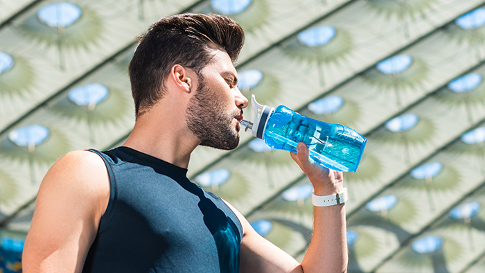 Athlete Drinking Out of Water Bottle